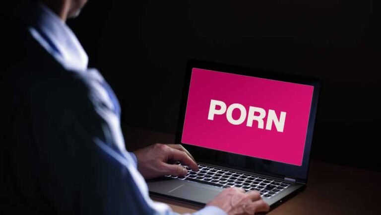 A person watching porn on laptop in dark