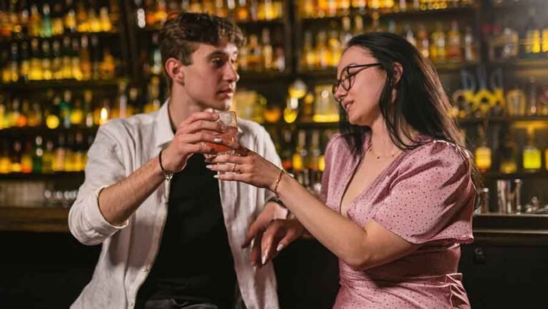 A man offering a free drink to a woman